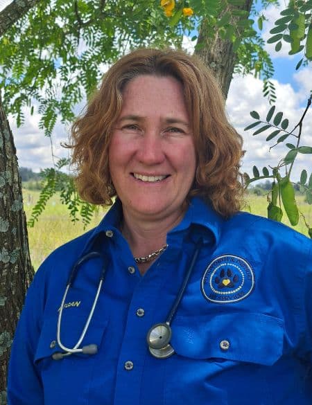 Vet megan in front of tree